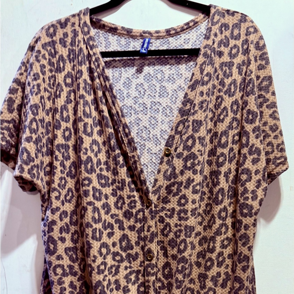 Iwollence animal print short sleeve button up shirt with tie at the bottom.